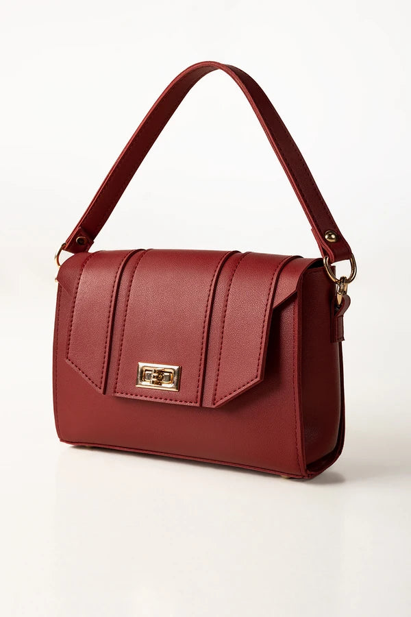 Red handbag with a gold clasp on a white background