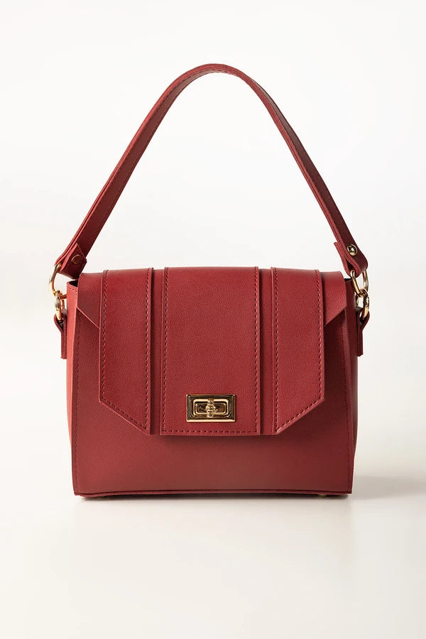 Red handbag with a gold clasp on a white background