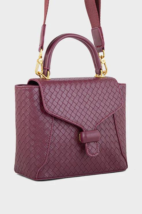 Maroon handbag with gold accents on a light gray background