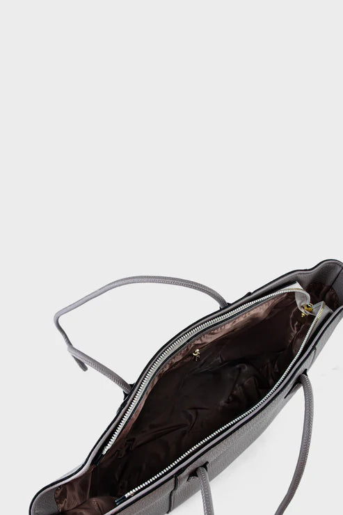 Black handbag with a visible zipper on a light gray background
