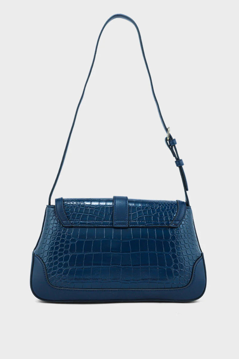 Blue handbag with a textured pattern on a light gray background