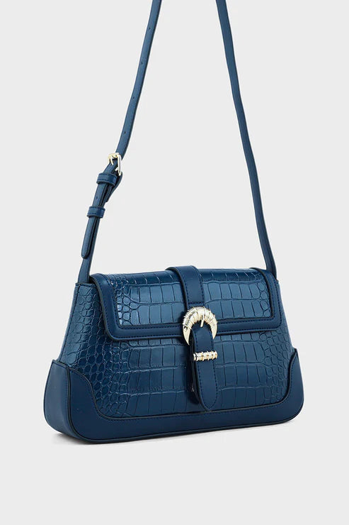Blue crocodile-patterned handbag with a silver clasp on a light gray background