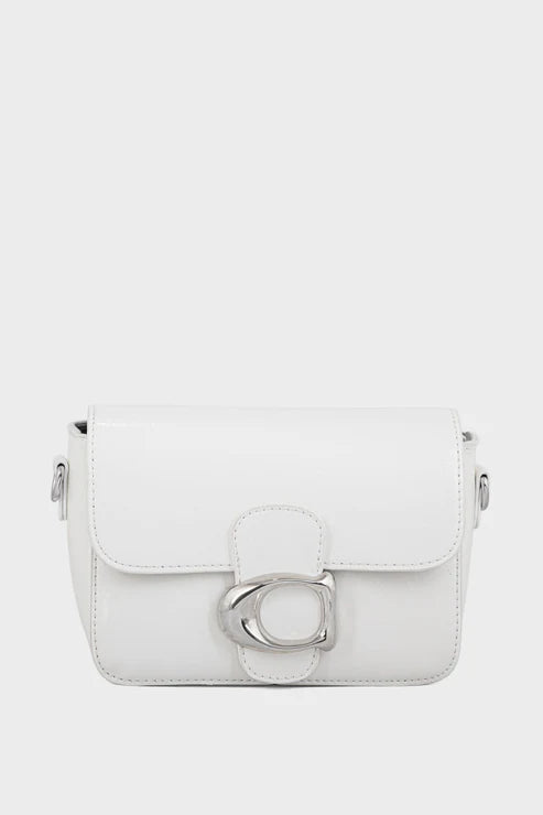 White handbag with a decorative clasp on a light gray background