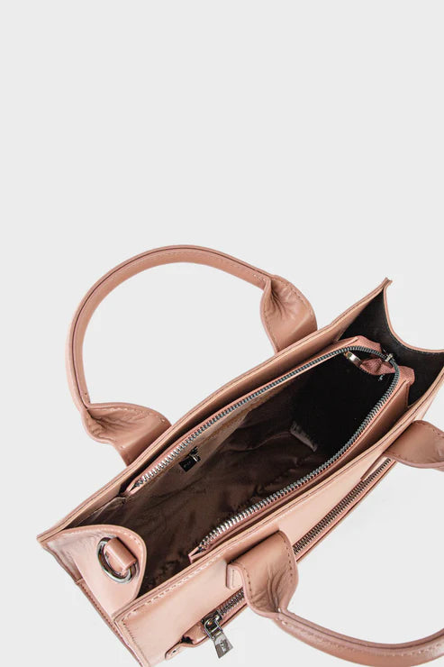 Rose gold handbag with open front compartment on a light gray background