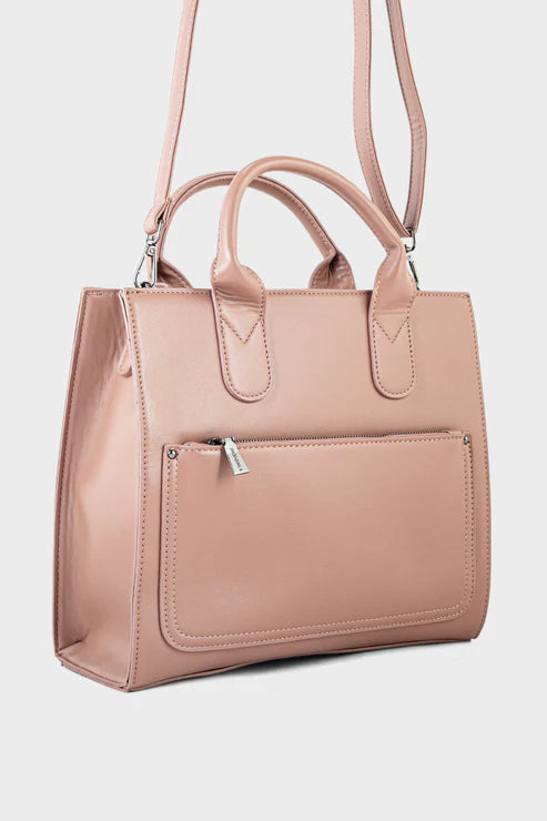 Pink handbag with a shoulder strap on a light gray background
