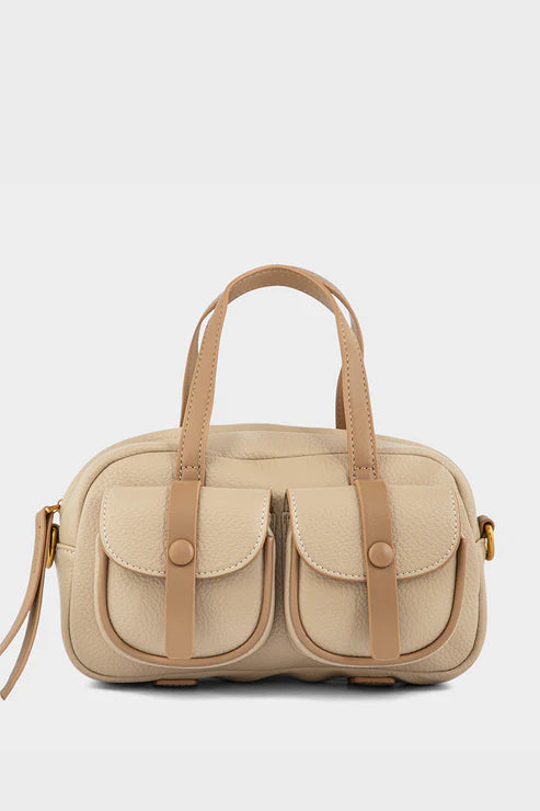 Beige handbag with brown leather straps on a light gray background