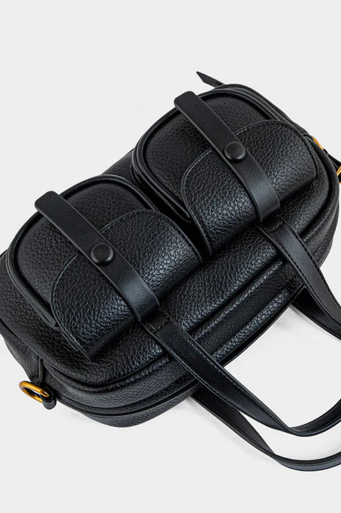 Black leather handbag with woven strap design on a white background