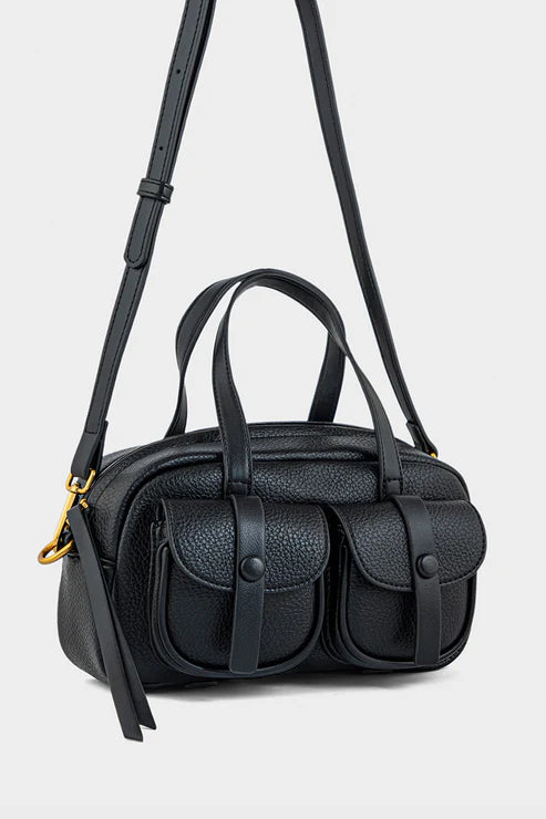 Black handbag with a strap on a light gray background