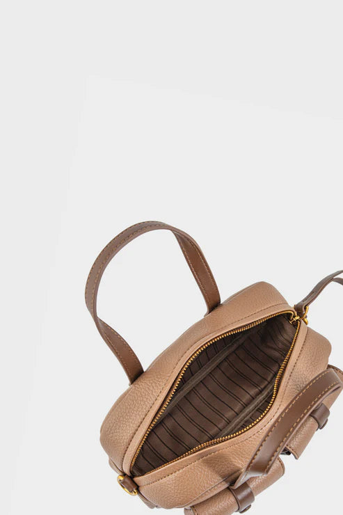 Brown leather backpack on a light gray background