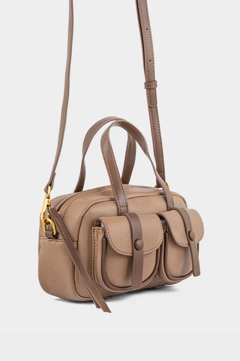 Beige handbag with brown straps on a light gray background