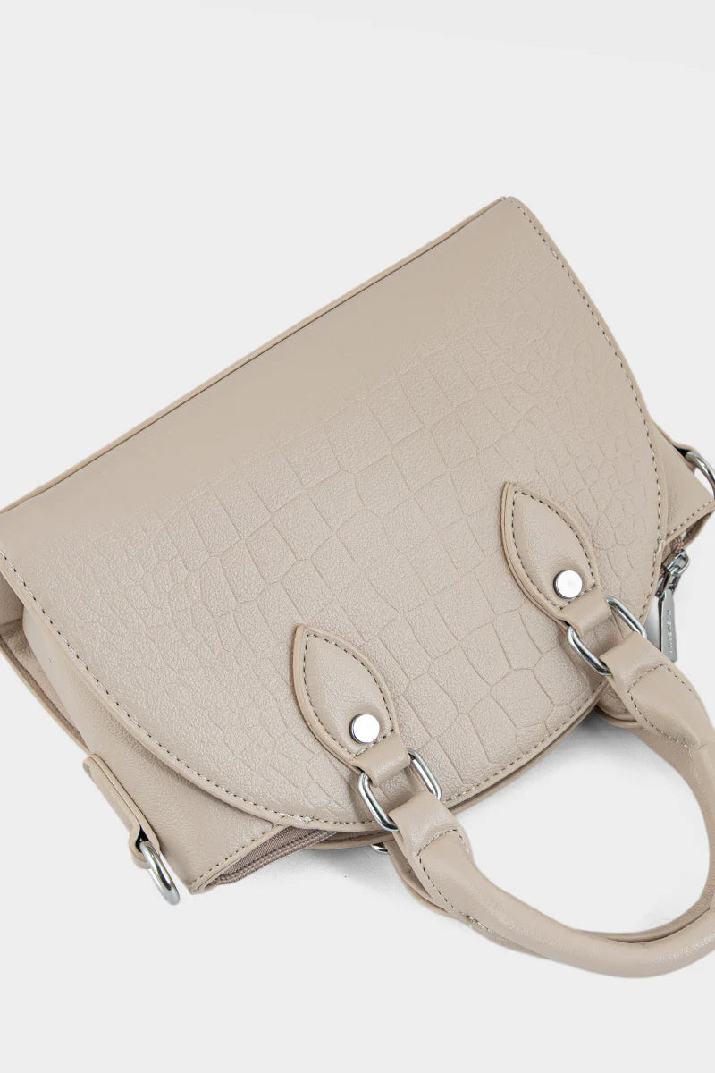 Beige handbag with silver handles and hardware on a white background