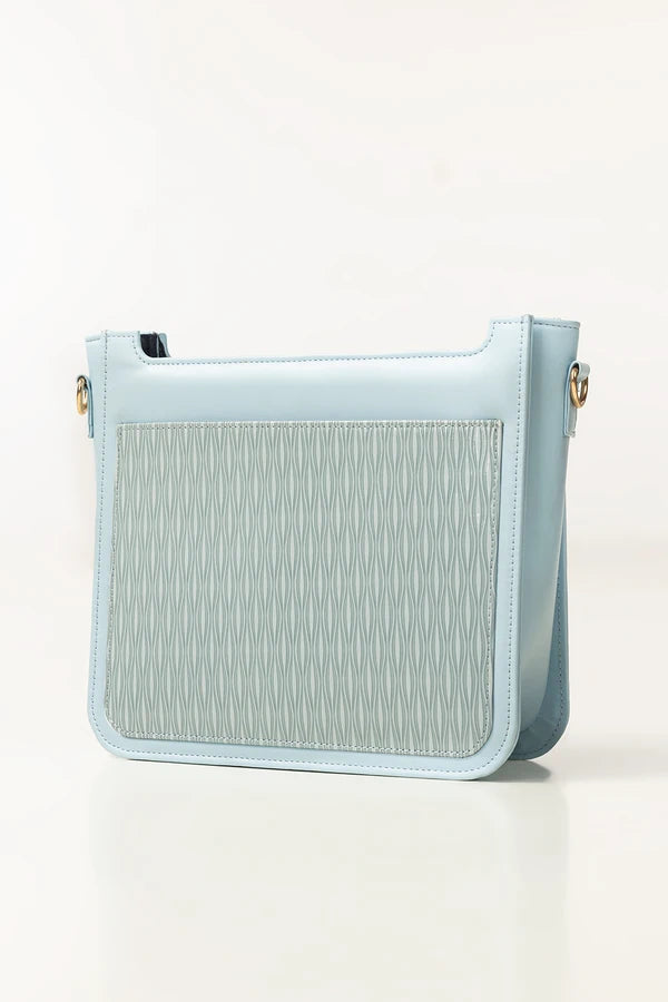 Light blue handbag with textured front panel on a white background