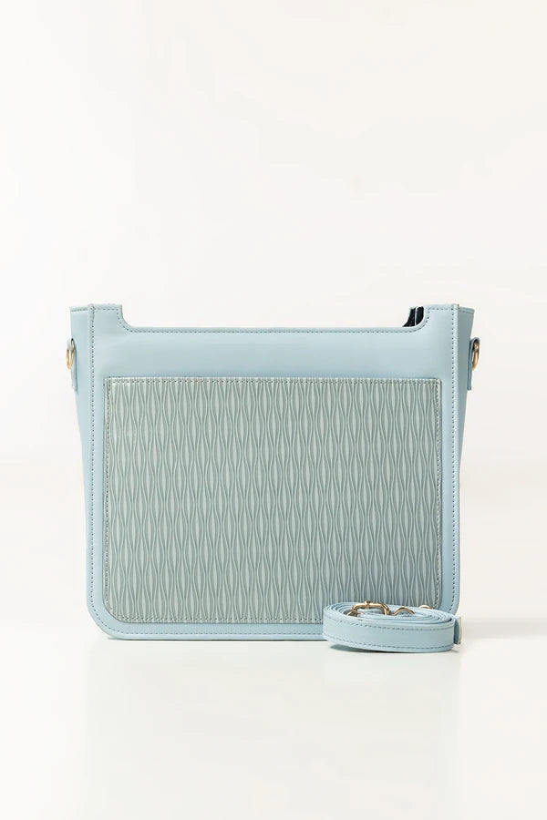 Light blue handbag with textured pattern on a white background