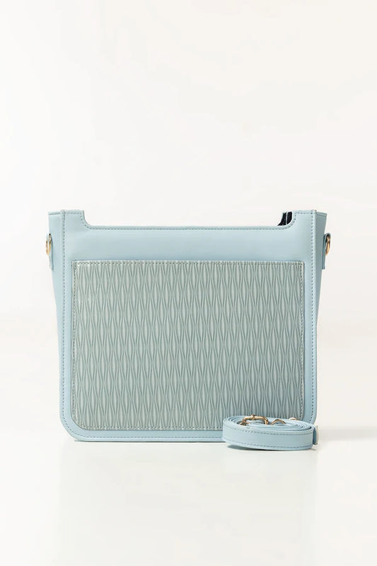 Light blue handbag with textured pattern on a white background