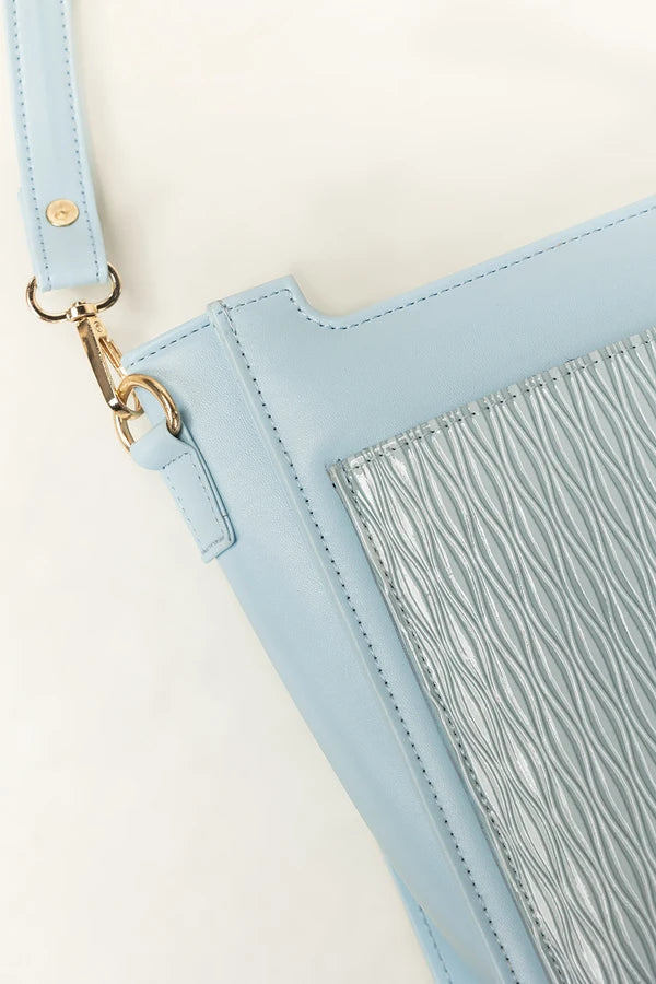 Light blue handbag with a strap and metallic fringe detail on a white background