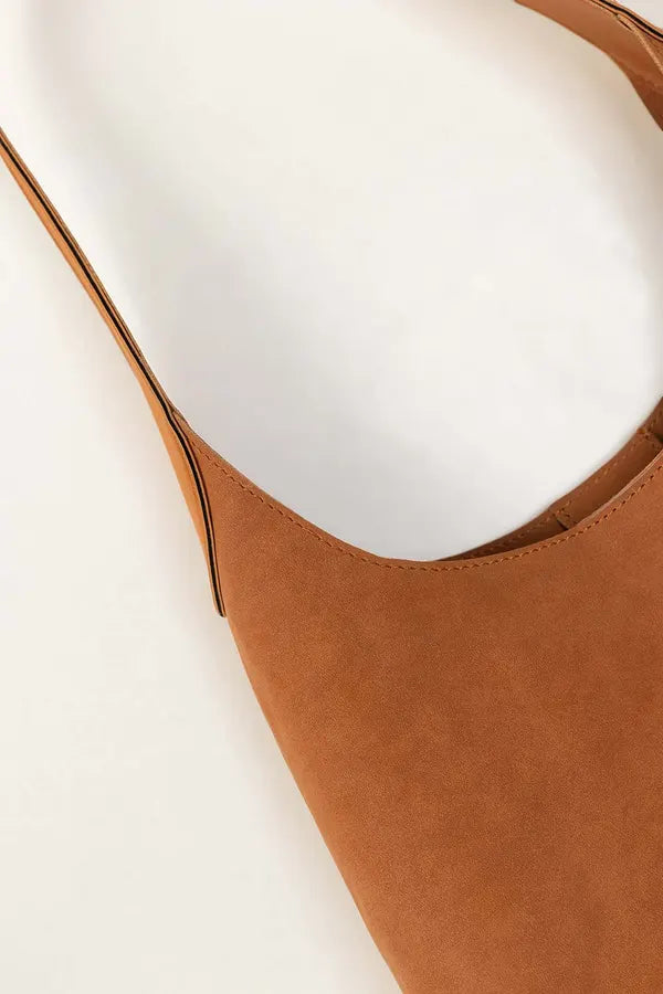 Brown leather bag on a white background