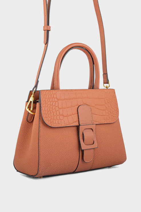 Brown handbag with gold accents on a light gray background