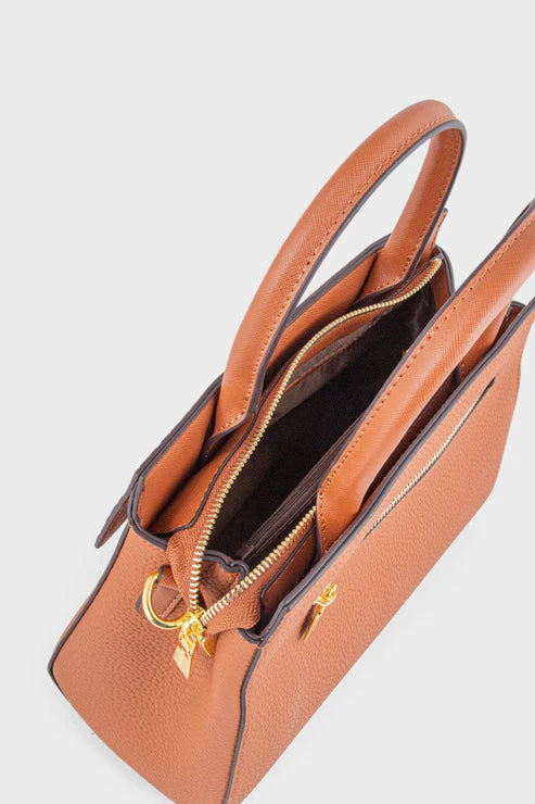 Brown handbag with gold zipper on a light gray background