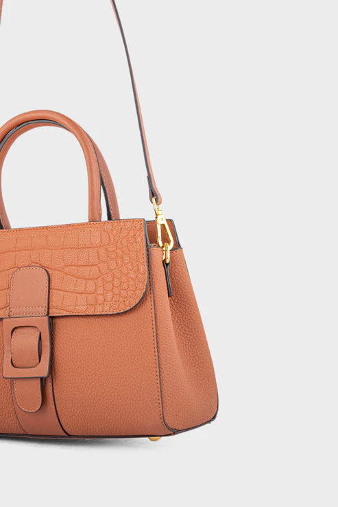 Brown handbag with a gold buckle on a light gray background